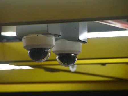 Two security cameras dome type install on the ceilingの写真素材