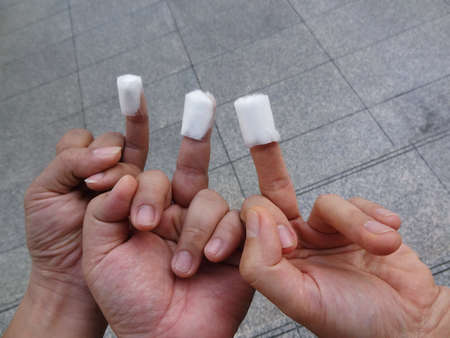 3 men hands with one of each Fingertip stick with medical cotton bandage after have Fingertip Blood...