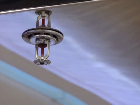 fire sprinkler install on reflective stainless sheet on high ceilingの写真素材