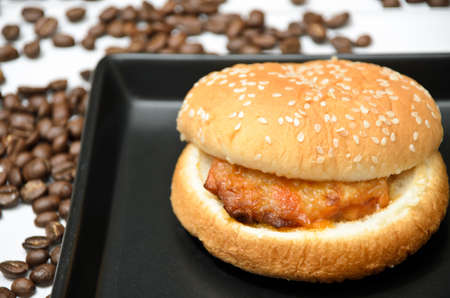 Chicken steak burger on black dishの写真素材