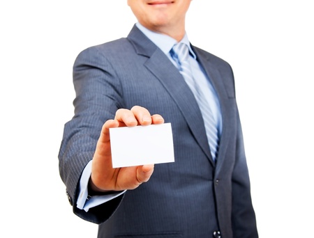 Business person in suit holding out blank white copy space card on isolated background  Focus on card の写真素材