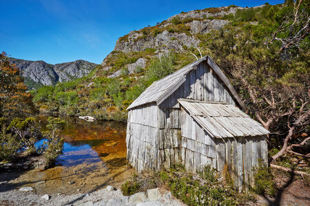 Old wooden hut by lakeside in Cradle Mountain Lake St  Clair National Parkのeditorial素材