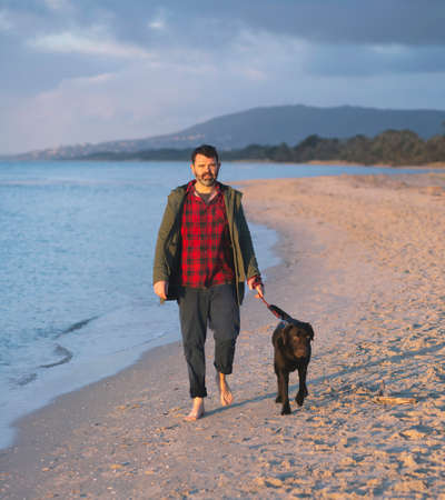 Man leisurely walking dogの写真素材