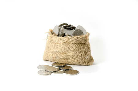 Bags filled with coins in white background  Isolated の写真素材