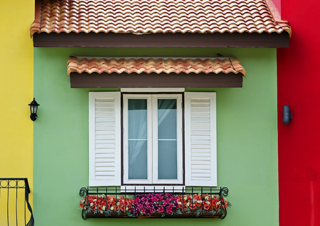 Vintage white window on the colorful houseの写真素材