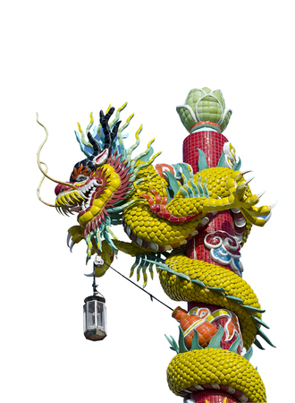 Statue of a dragon wrapped around a pole isolate on white background.の写真素材