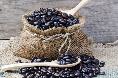 Fresh coffee bean in the bag with spoon in wooden の写真素材