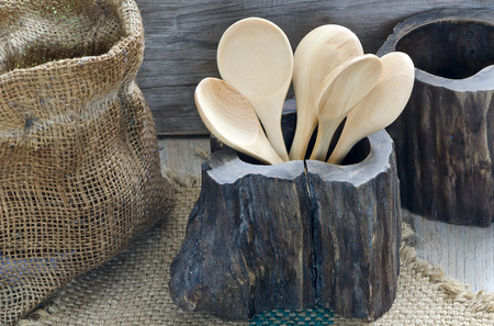 Wooden spoons in wooden box on nature background.の写真素材