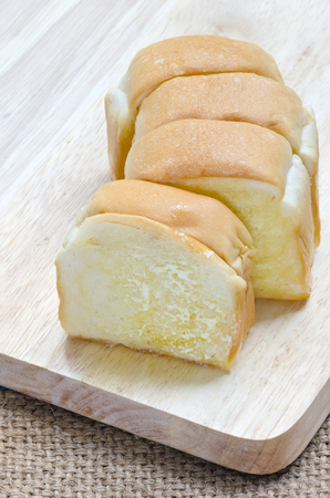 Sliced  bread with cream and sugar on wooden background.の写真素材