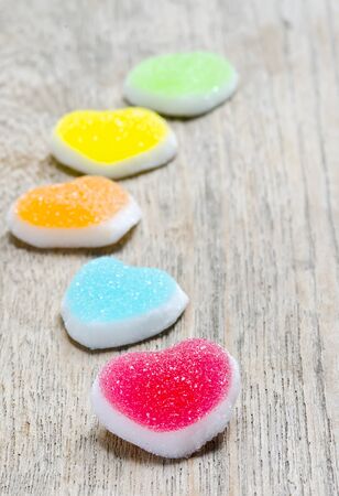 Colorful of jelly candy with heart sign on wooden background.の写真素材