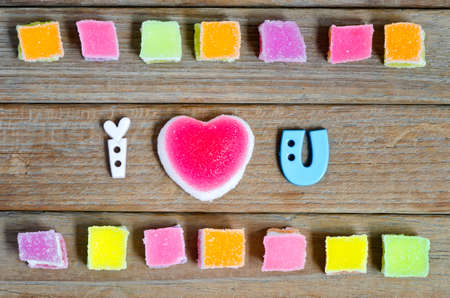 Colorful of jelly candy with heart sign on wooden background.の写真素材