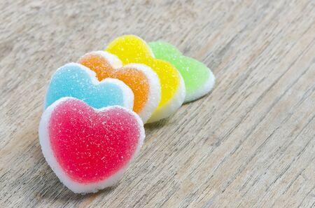 Colorful of jelly candy with heart sign on wooden background.の写真素材