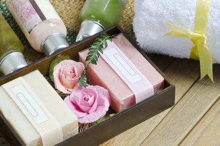 Pink and white natural soap spa with white towel on wooden background.の写真素材