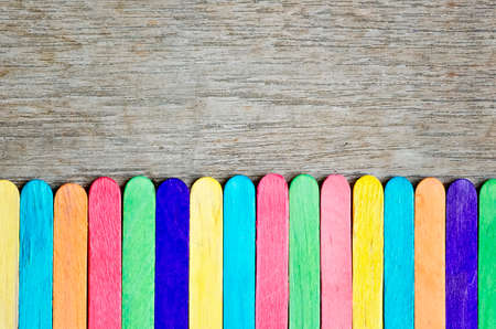 Colorful of wood ice cream stick on wooden background.の写真素材