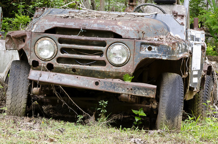 Broken and  rusty  car in the junk yardの写真素材