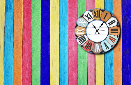 Vintage clock on the colorful f wooden wall background.の写真素材