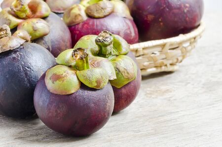 Fresh  mangosteens  placed on a wooden table