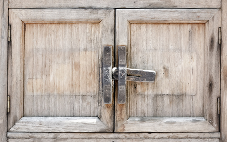 Old and fade wooden window with the lock  in Thai styleの写真素材