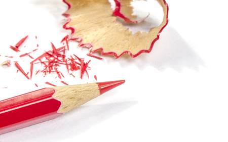 Red pencil and pencil shaving on white background.の写真素材