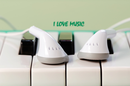 White  earphone on the keyboard of melodian,soft focus.の写真素材