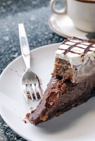 Piece of chocolate cake on white plateの写真素材