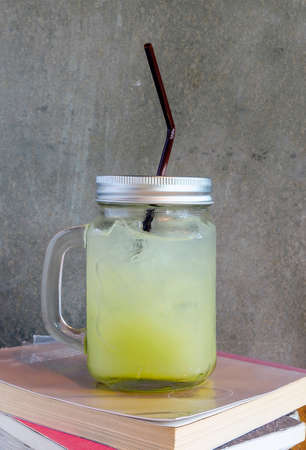 Bottle of fresh guava juice  on the bookの写真素材