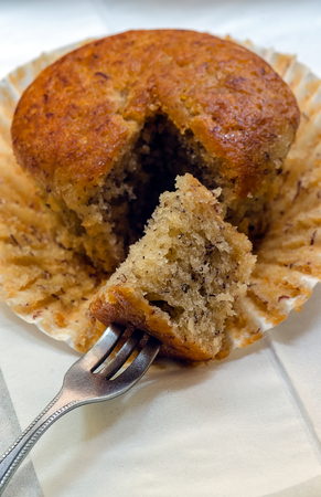 Banana muffin cupcakes and fork in close up view,soft focus.の写真素材