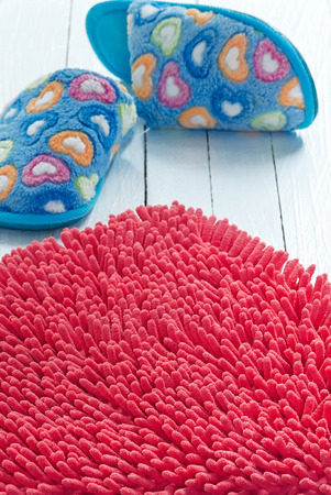 Foot Wipes and House slippers on wooden background.の写真素材