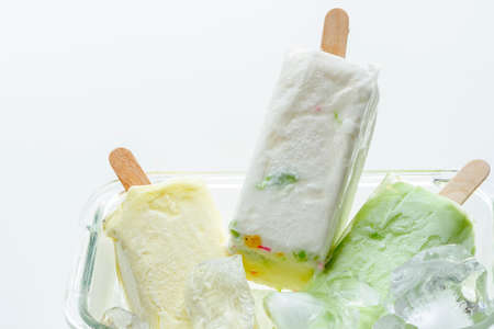 homemade ice cream with ice cubes in the glass bowl on white backgroundの写真素材
