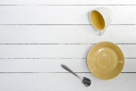 Empty Cup, saucer and spoon on wooden background,top view.の写真素材