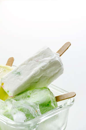 homemade ice cream with ice cubes in the glass bowl on white backgroundの写真素材