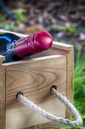Bottle of red wine  in the wooden box,close up view.の写真素材