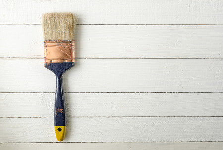 Old paint brush on wooden backgroundの写真素材