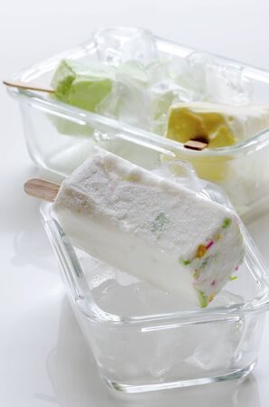 homemade ice cream with ice cubes in the glass bowl on white table.の写真素材