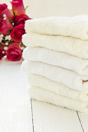 Stack of towels on white wooden background.の写真素材
