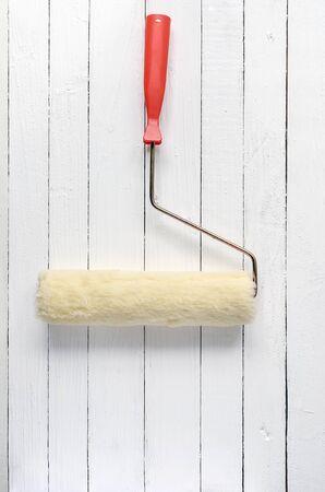 brush roller on white wooden background.の写真素材