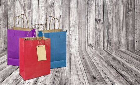 Colorful paper bag on  wooden  plank  background.の写真素材