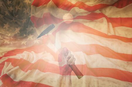 Hand holding hammer with usa flag background,design for labor day concept.の写真素材