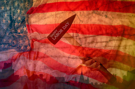 Hand holding hammer with usa flag background,design for labor day concept.の写真素材