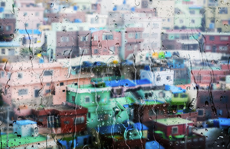 colorful building behind the glass window with rain drop.の写真素材