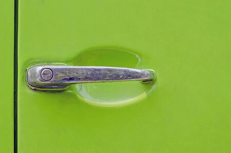 dirty  door handle of old green car in close up viewの写真素材
