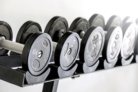 Sports dumbbells in  sports club. Weight Training Equipment,white backgroundの写真素材