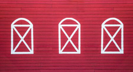 Background image of a wooden wall painted in bright red and white colorの写真素材