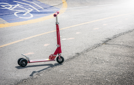 Red scooter on the asphalt roadの写真素材