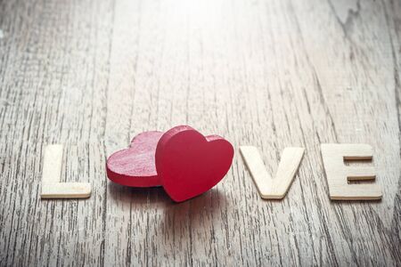 Valentines day background with two red hearts shape on wooden backgroundの写真素材