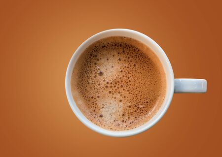 white cup of coffee  on brown color background,top viewの写真素材