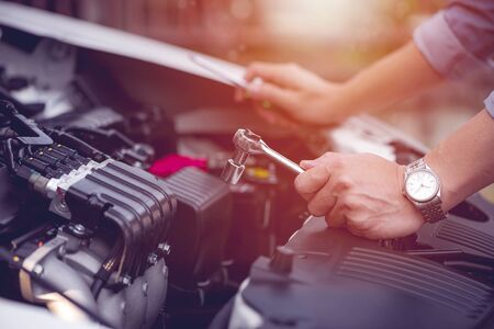 cropped image of man hand repairing a broken car ,sunlight effectの写真素材