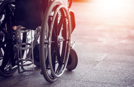 Close-up Empty wheelchair in front of the Outpatient Department of Hospital with sunlightの写真素材