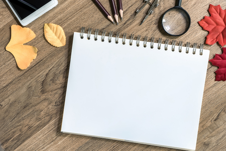 Open notebook with white blank sheets on wooden table,Top view, Concept of workplace, equipment,の写真素材