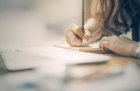 Close up of female designer hands at workplace drawing something with pencil. Project conceptの写真素材